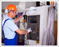 Machinist at control panel