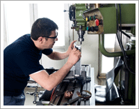 Machinist working with lathe in a production shop